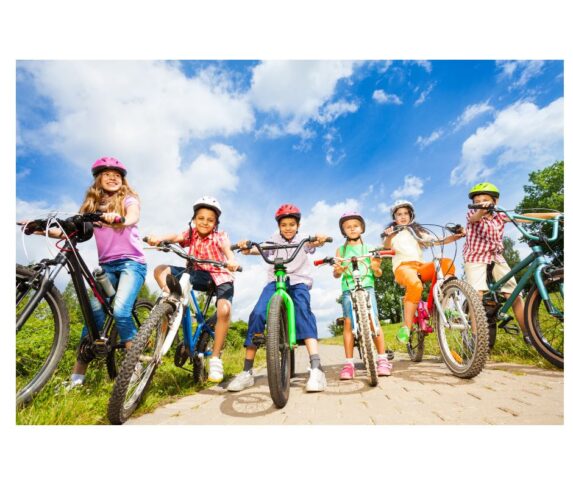 a diverse mix of kids wearing helmets on bikes