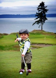 Child on golf course holding golf club